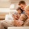 lifestyle image of a family laughing and looking at a book