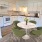 rendering of kitchen showing connected dining area and wood-style flooring